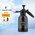Black 2L foam watering can sprayer with handle and two nozzle attachments on a white background