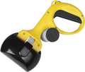Black pet pooper scooper with built-in bag holder and top carry hook on a grassy background.