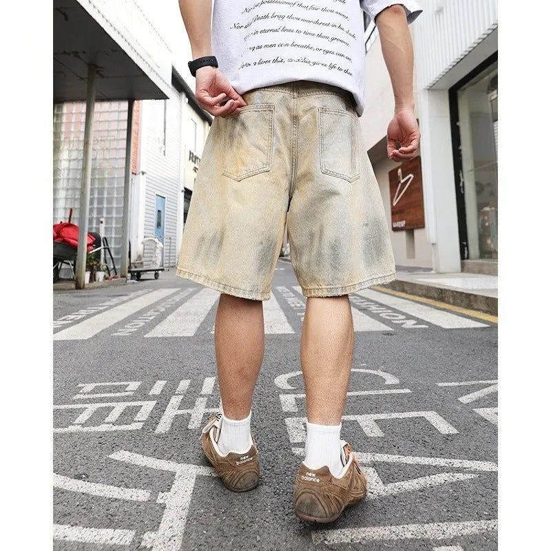 Men's light blue washed ripped straight-leg denim shorts on model front view