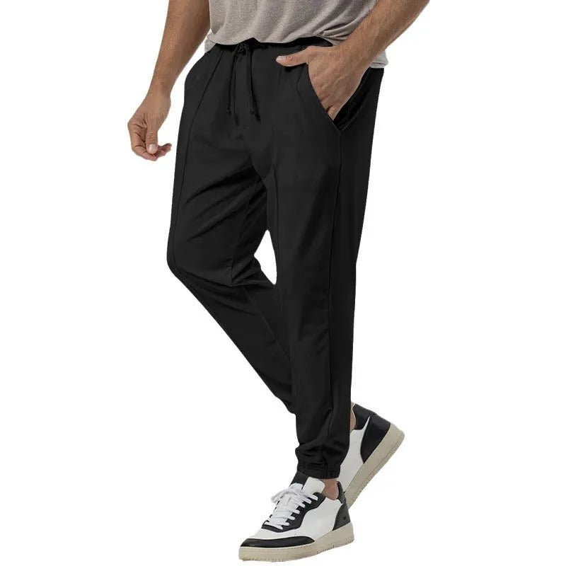Men's grey cotton blend track sweatpants with elastic waistband and straight-leg design