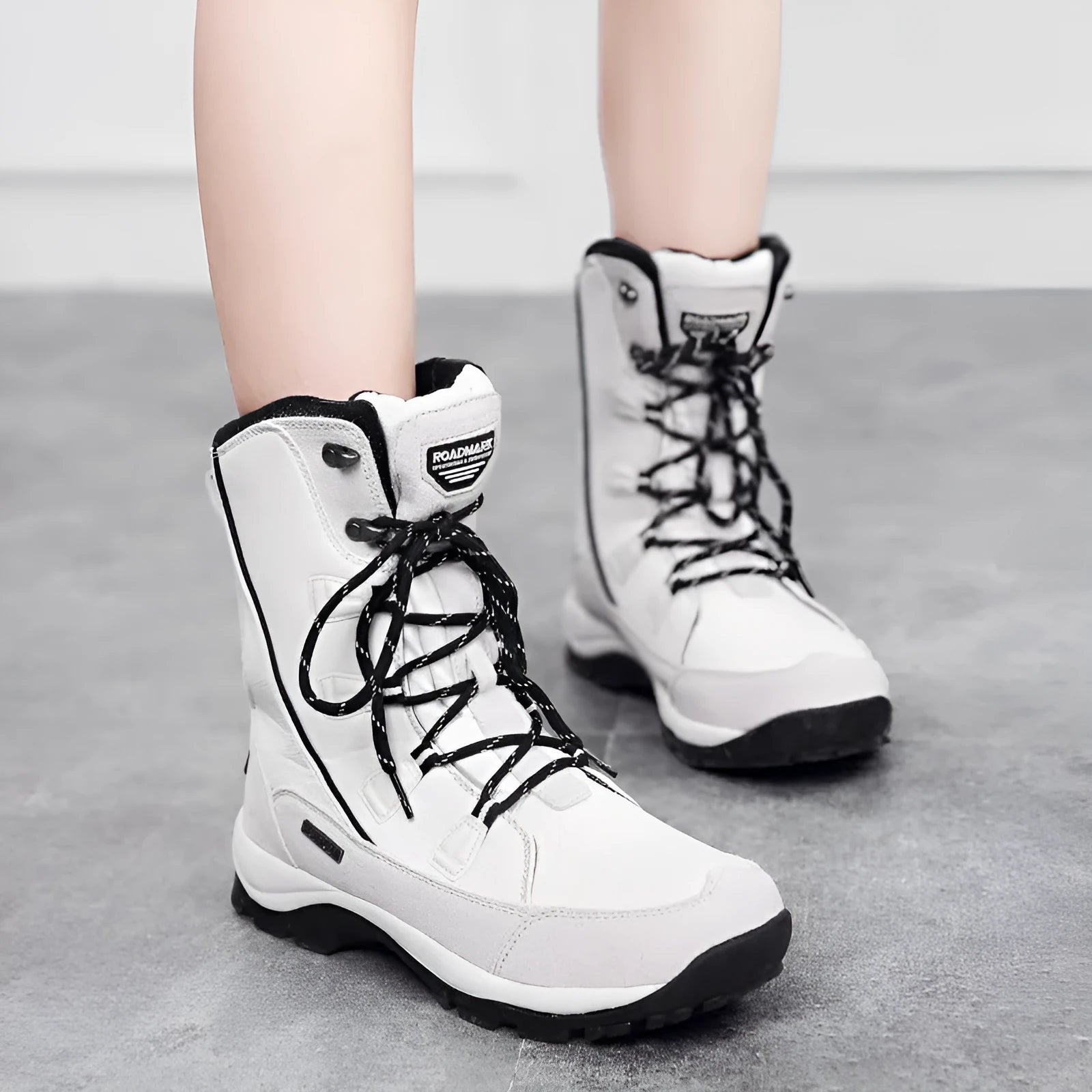 Women's black waterproof thermal snow boots with a genuine leather upper and mid-calf height