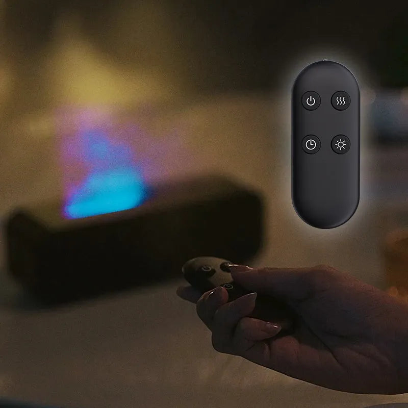 Black aroma diffuser with glowing orange flame effect and colour-changing LED base on a wooden table
