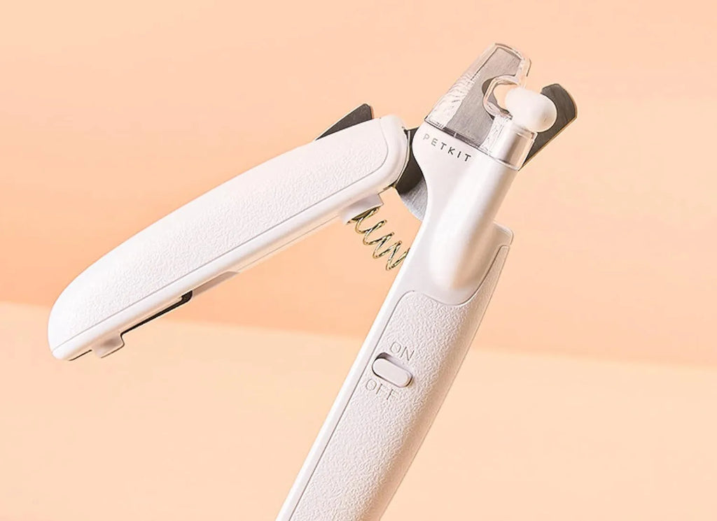 White pet nail clippers with LED light, transparent anti-splash guard, and a leather-like handle.