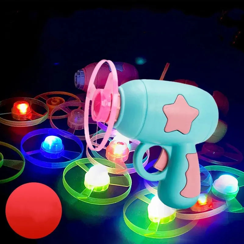Flying saucer launcher toy with three blue flashing LED discs and target board on blister card