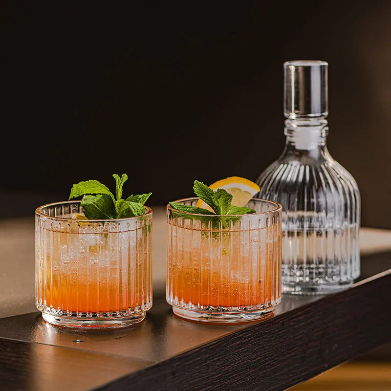 Clear glass cup and pot set with striped and diamond pattern designs for whiskey or wine