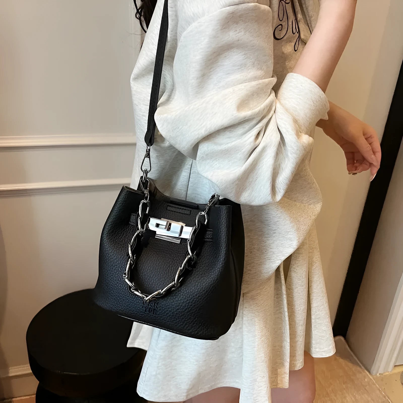 Soft PU retro bucket bag with chain detail on woman's shoulder