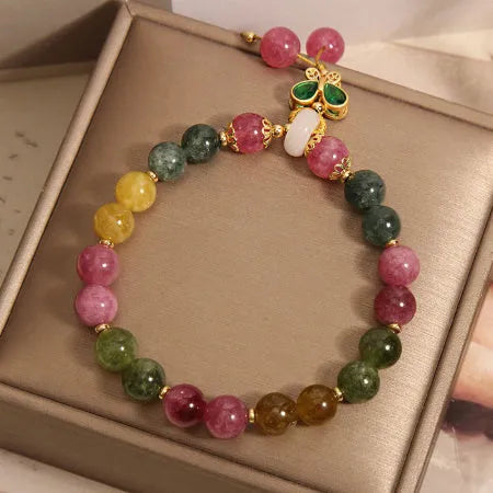 Colourful tourmaline butterfly pendant bracelet with alloy inlay and rhinestone accents on women's wrist