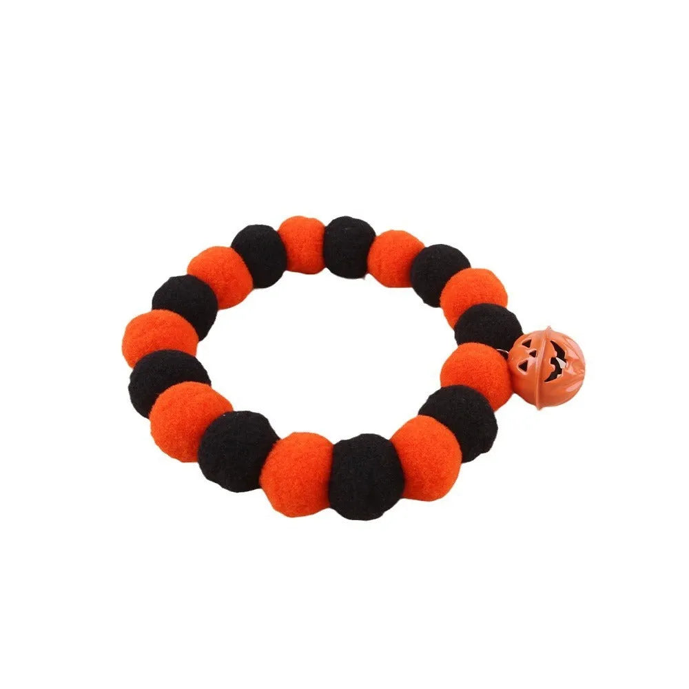 Orange pumpkin Halloween cat collar with green stem on an adjustable strap for pets.