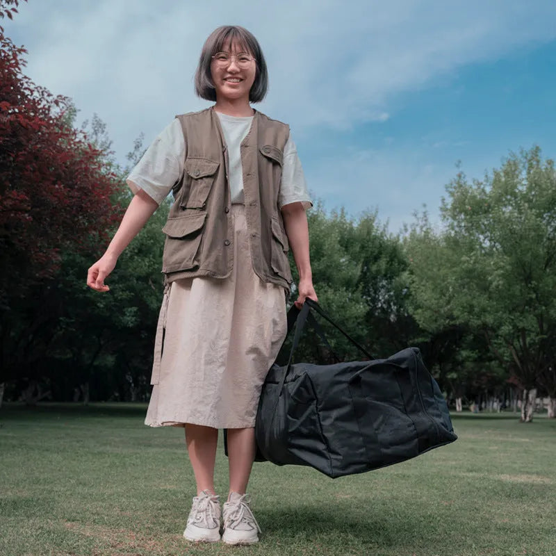 Large black waterproof storage bag for camping tents, tables, and chairs, shown with size dimensions.