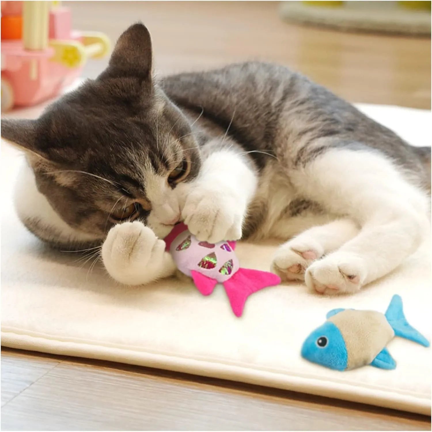 Two soft plush goldfish-shaped catnip cat toys with crinkle paper on a light background