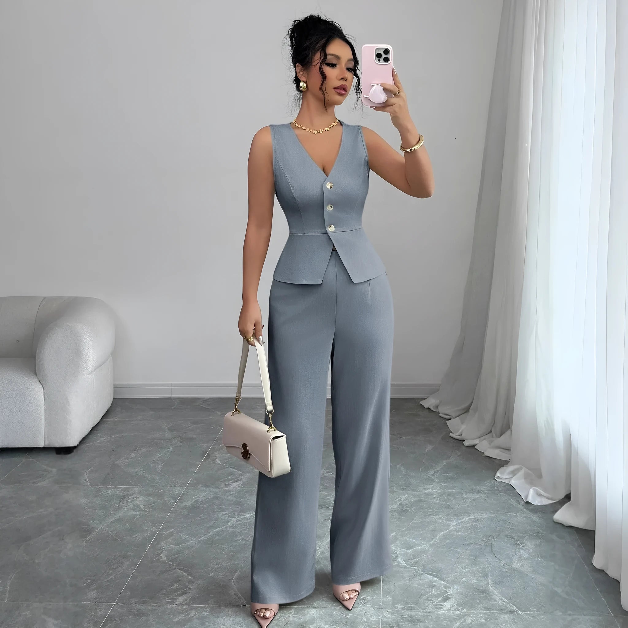 Women's black sleeveless vest and high waist trousers two-piece casual set.
