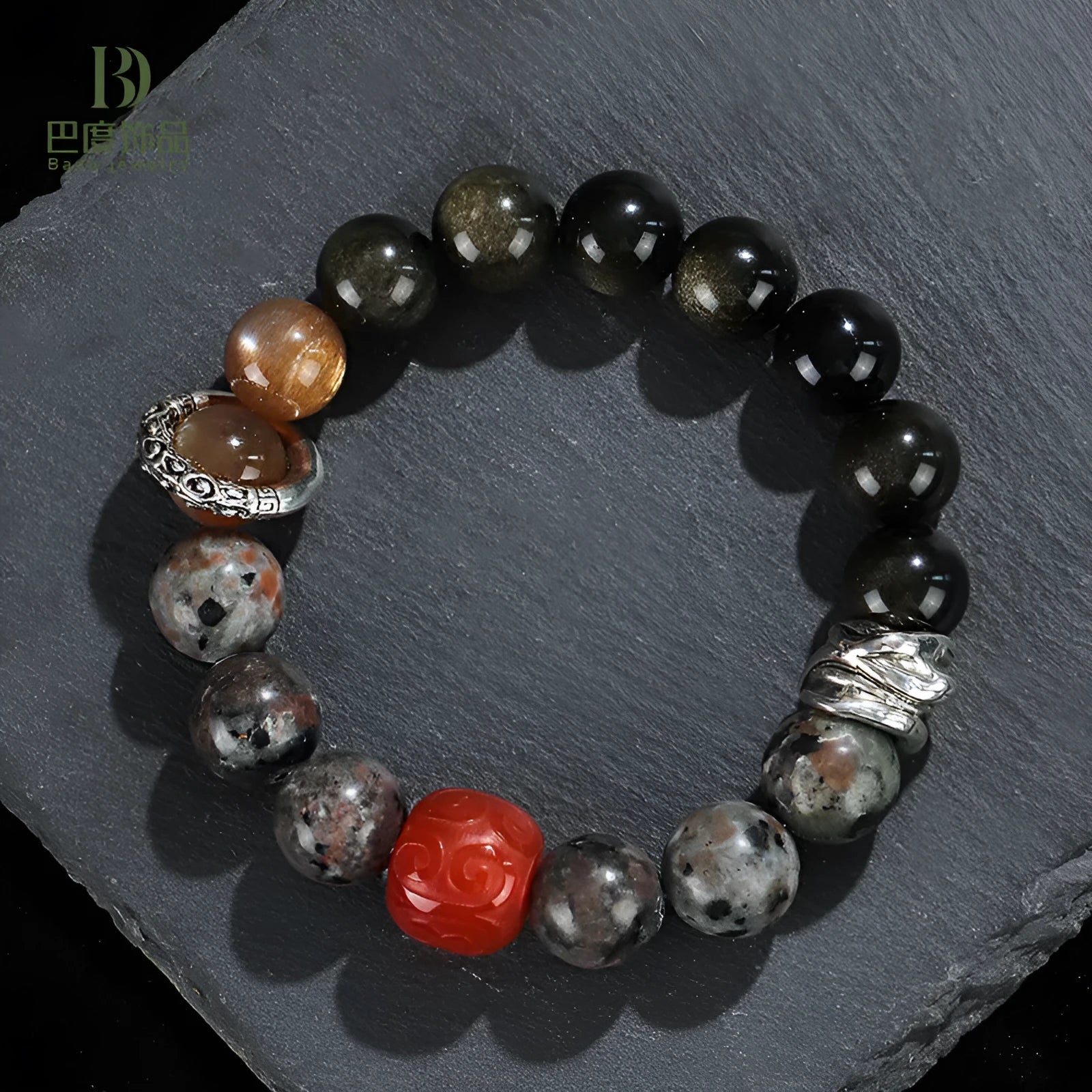 Gold obsidian flame stone and red agate unisex bracelet on a neutral background