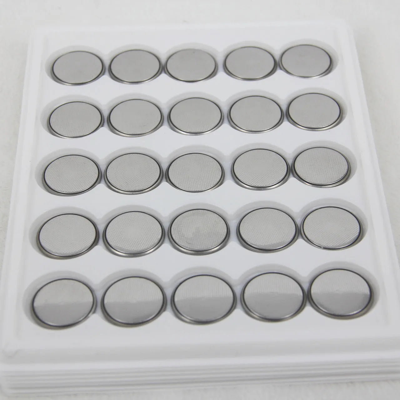 3V button battery CR2032 alkaline cell 20mm diameter on white background