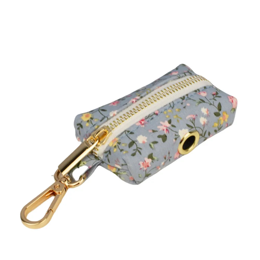 Blue floral dog collar with matching bow accessory on white background