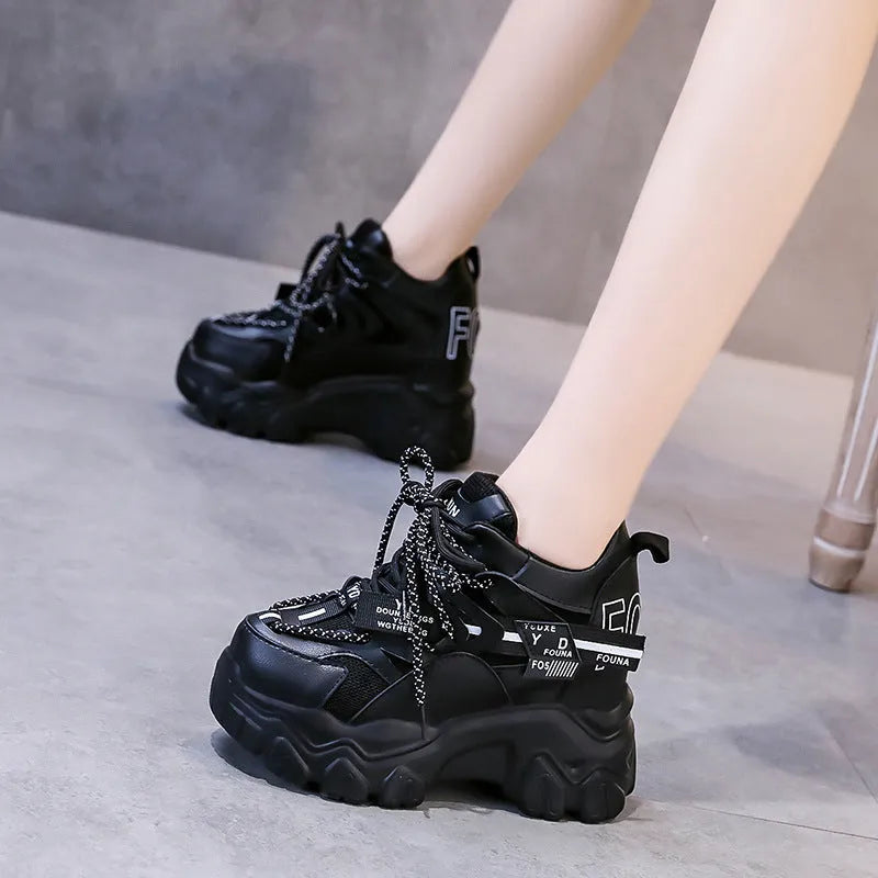 Women's white mesh platform trainers with cross strap and rubber sole showing side profile