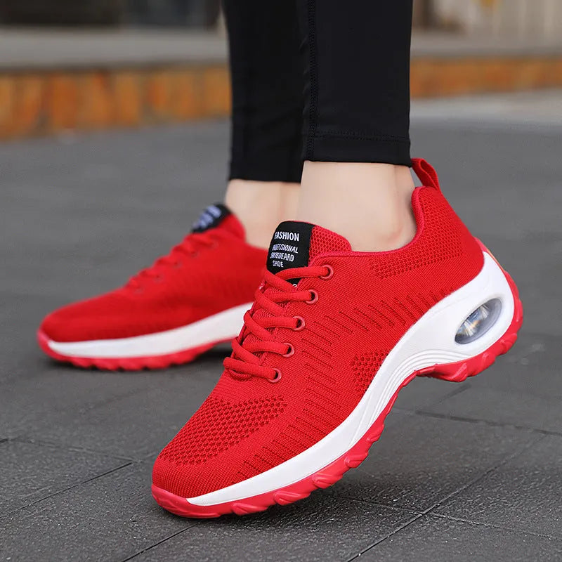 Women's round toe black mesh sneakers with white laces on a flat PU sole.
