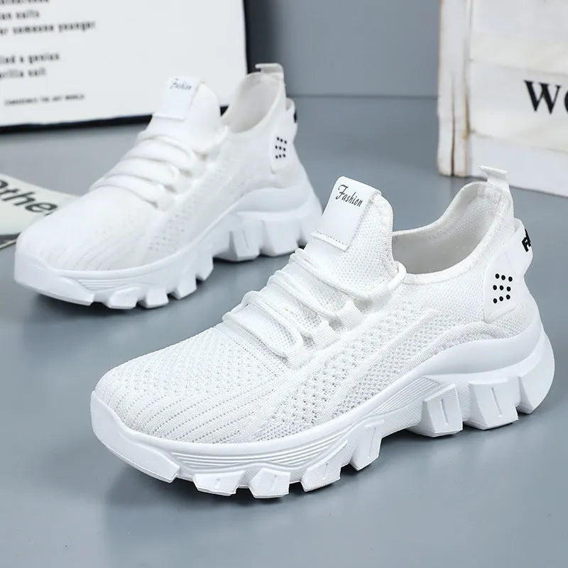 Men's white Flyknit running shoes with thick PVC sole and lace-up front.