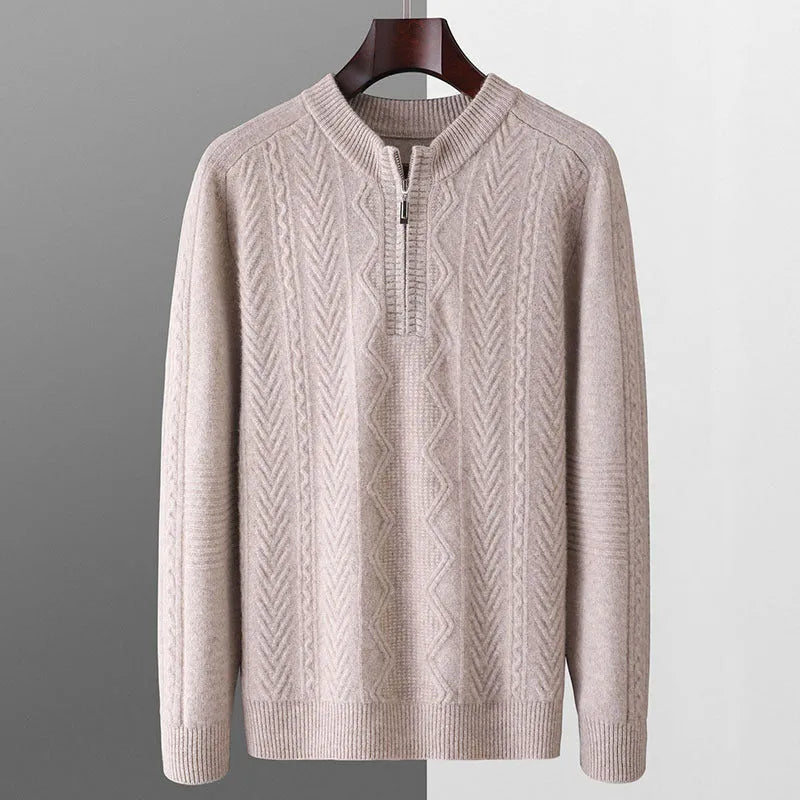 Man wearing a loose-fit, light-coloured wool sweater with a diamond lattice pattern and a half-zip front.