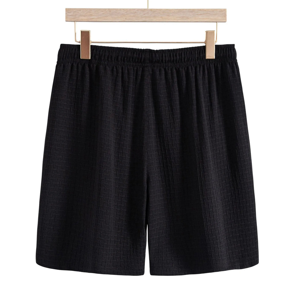 Men's black cotton blend short sleeve shirt and shorts casual summer suit on a hanger.