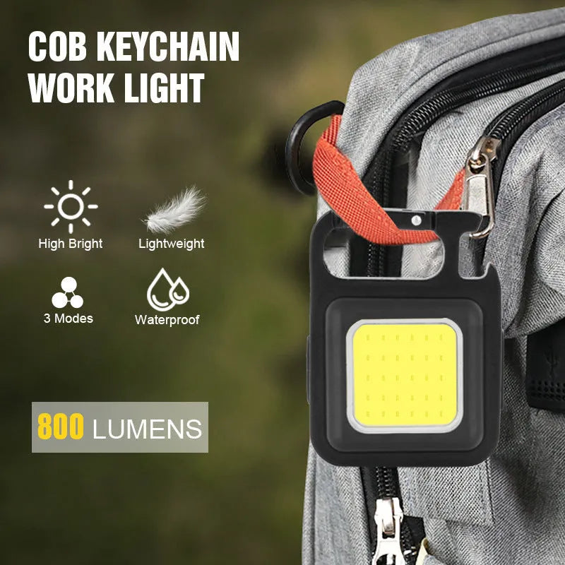 Black aluminium alloy COB keychain light with magnetic base, foldable handle, and key ring, 6x4.2cm