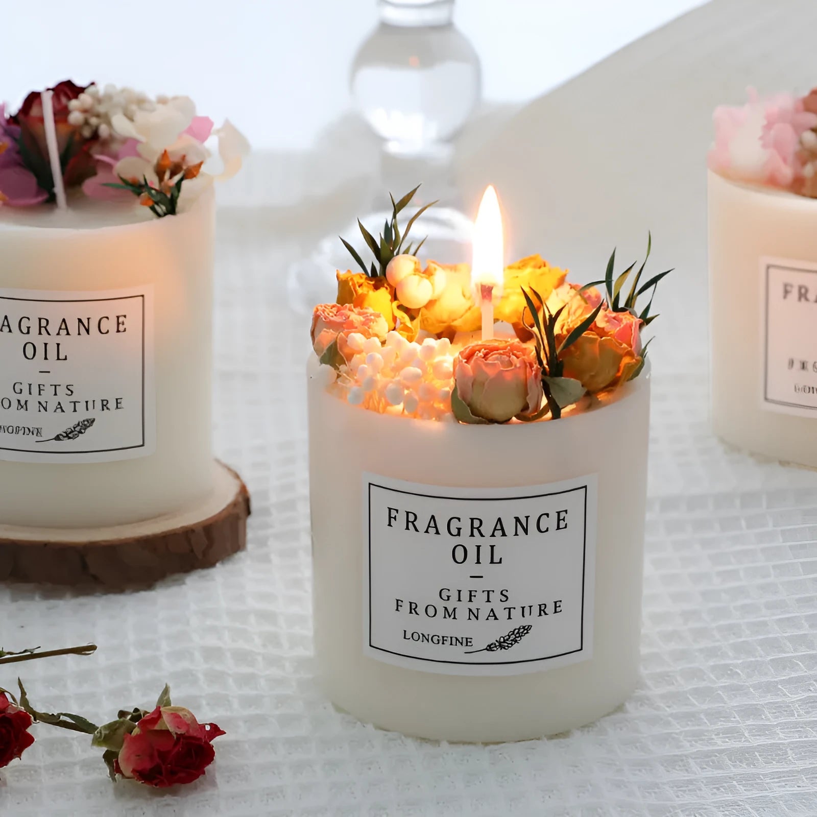 Aromatherapy candle with dried flowers on top, shown in various scent style options.
