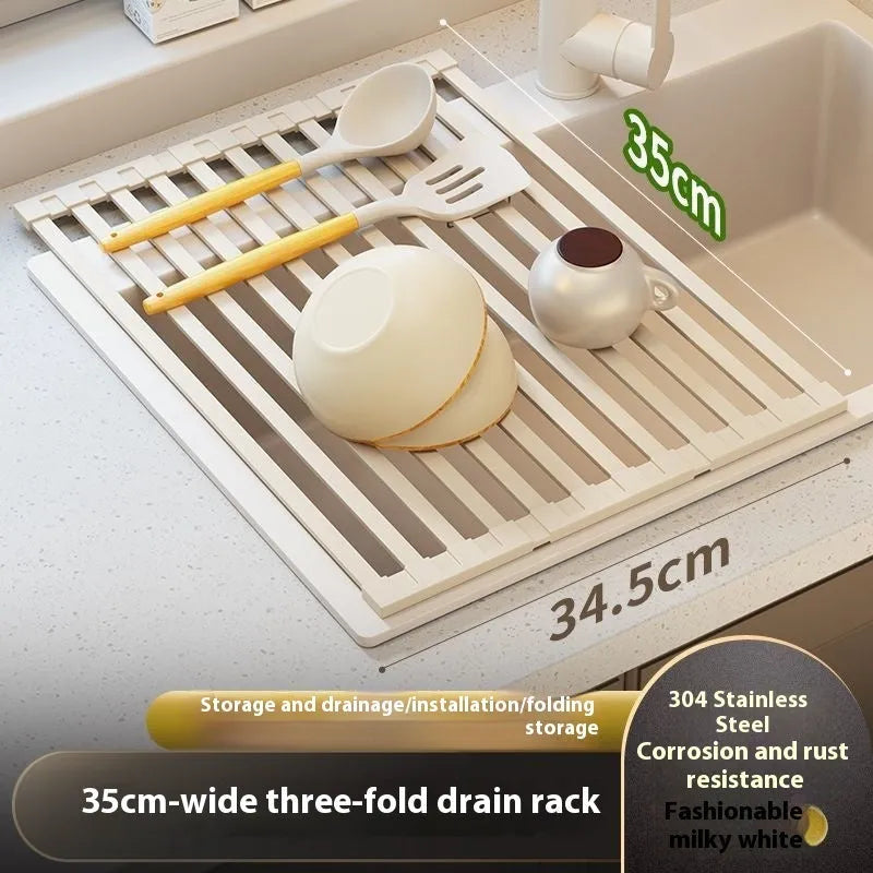 Milky white foldable stainless steel kitchen draining rack placed next to a sink.