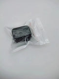 Black plastic ABS seat belt lock catch clamped onto a car seat belt buckle, side view