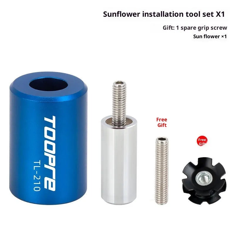 Blue sunflower driving tool for bicycle bowl group hanging core installation, made from aluminium alloy and stainless steel, on a workbench.