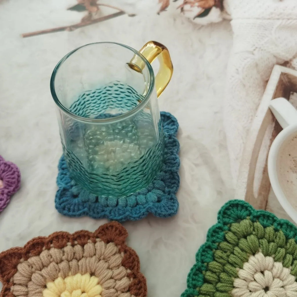 Crocheted wool grandmother lattice insulated cup placemat in four colours Emerald Sea Salt Blue Dream Purple Fog Brown