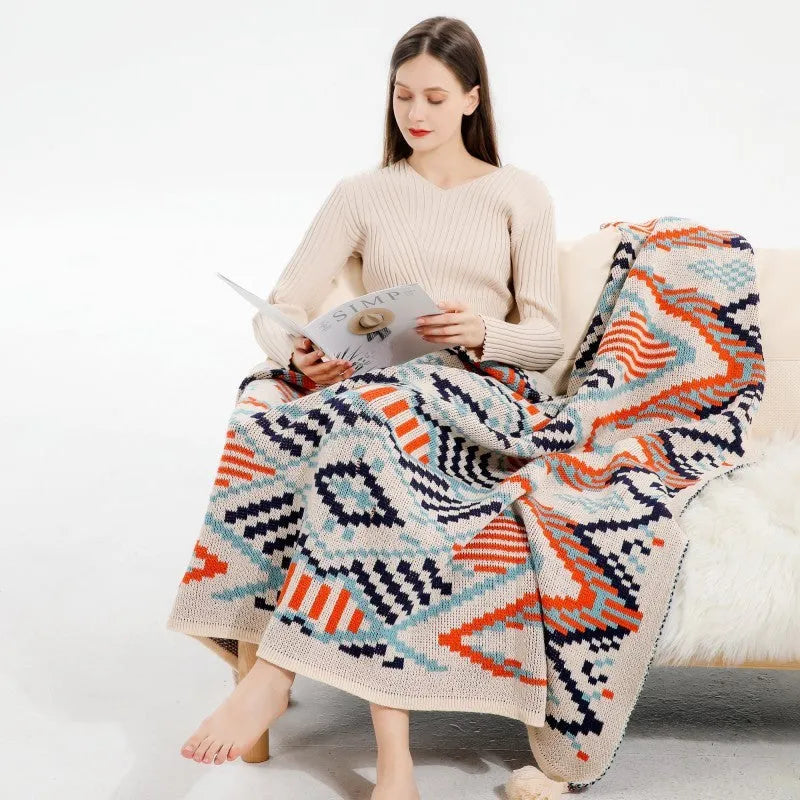 Bohemian style acrylic sofa throw blanket with tassel trim in a geometric pattern colour