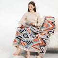 Bohemian style acrylic sofa throw blanket with tassel trim in a geometric pattern colour