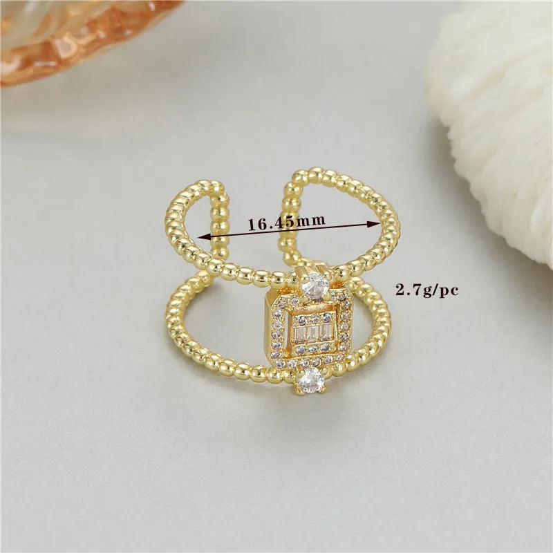 Gold tone adjustable open ring with U-shaped design and asymmetrical silhouette