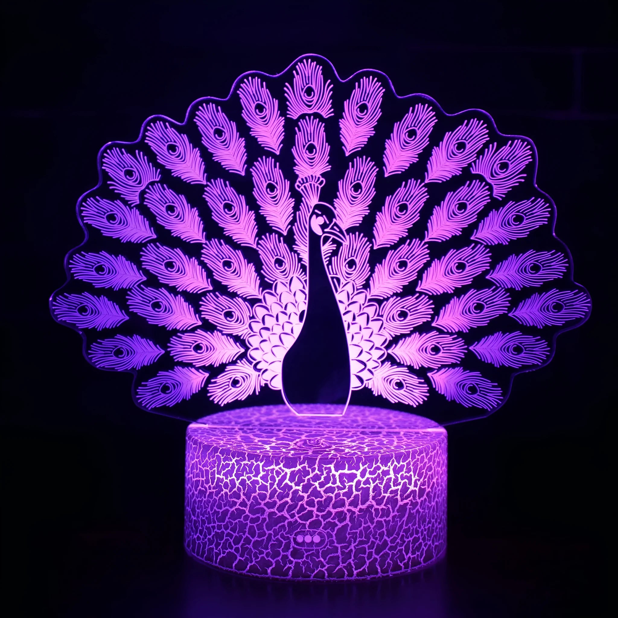 Small colourful acrylic 3D USB table lamp with touch control and crack base design on a desk.