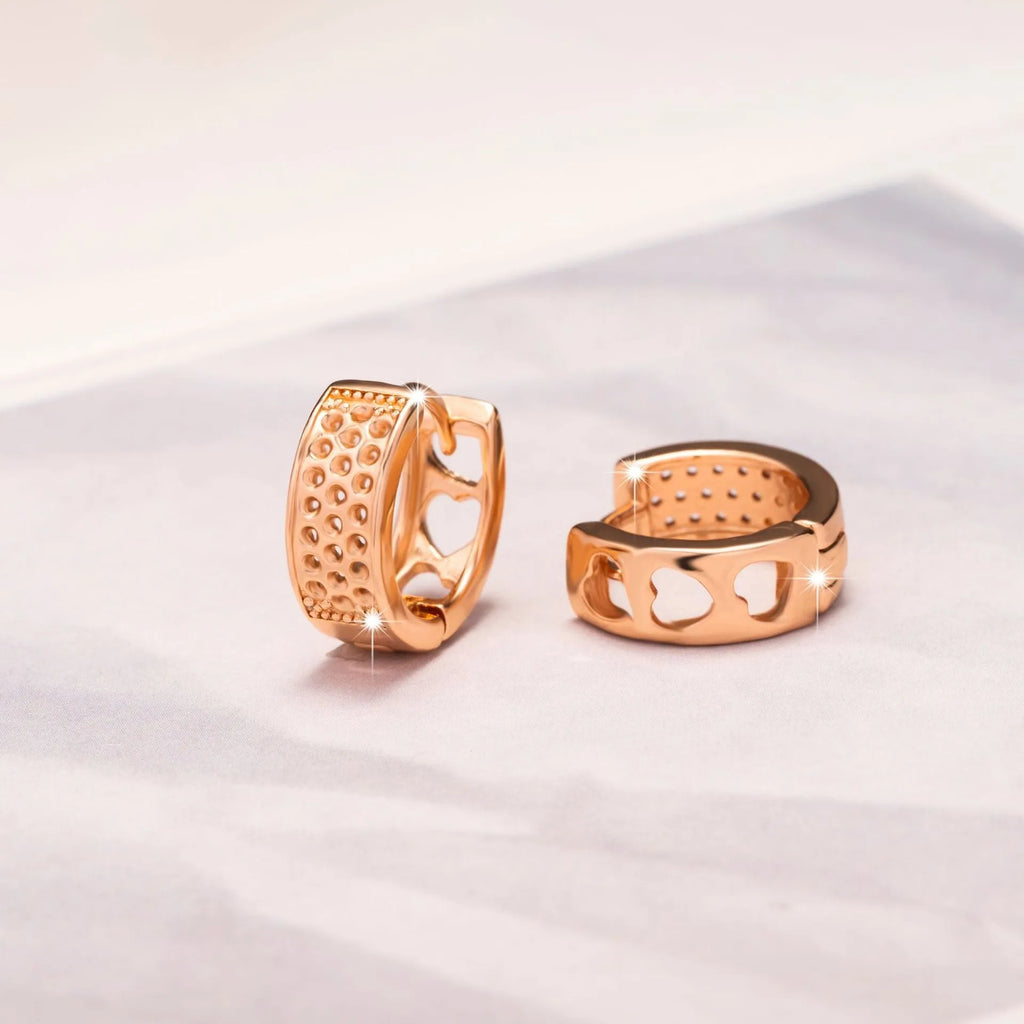 Rose gold circular earrings with three hollow heart cut-outs