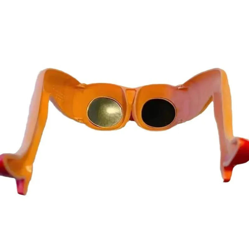 Orange plastic novelty sunglasses shaped like legs and hips on a white background.