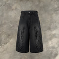 Men's black denim shorts with cropped flame embroidery patch on leg, straight cut.