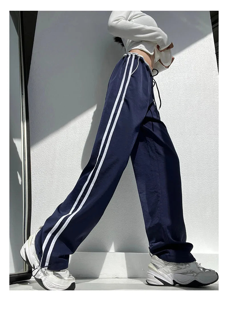 Women's navy blue parallel bars contrast colour loose straight leg trousers on a low waist.
