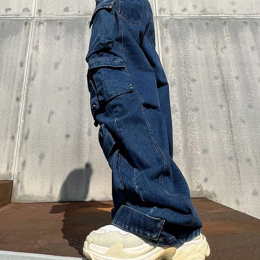 Dark blue distressed wide-leg high-waist jeans with multiple pockets on a street fashion model