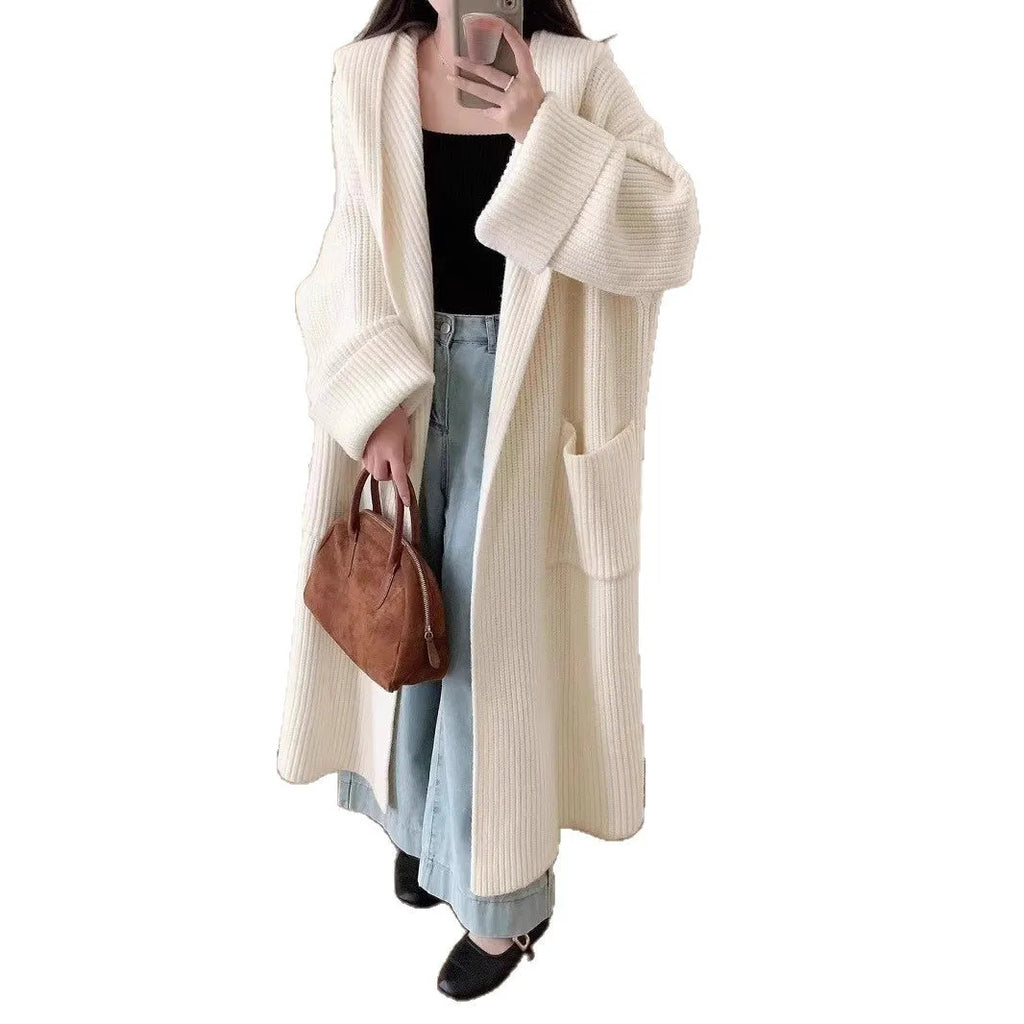 Women's loose grey hooded cardigan coat with raglan sleeves on a hanger