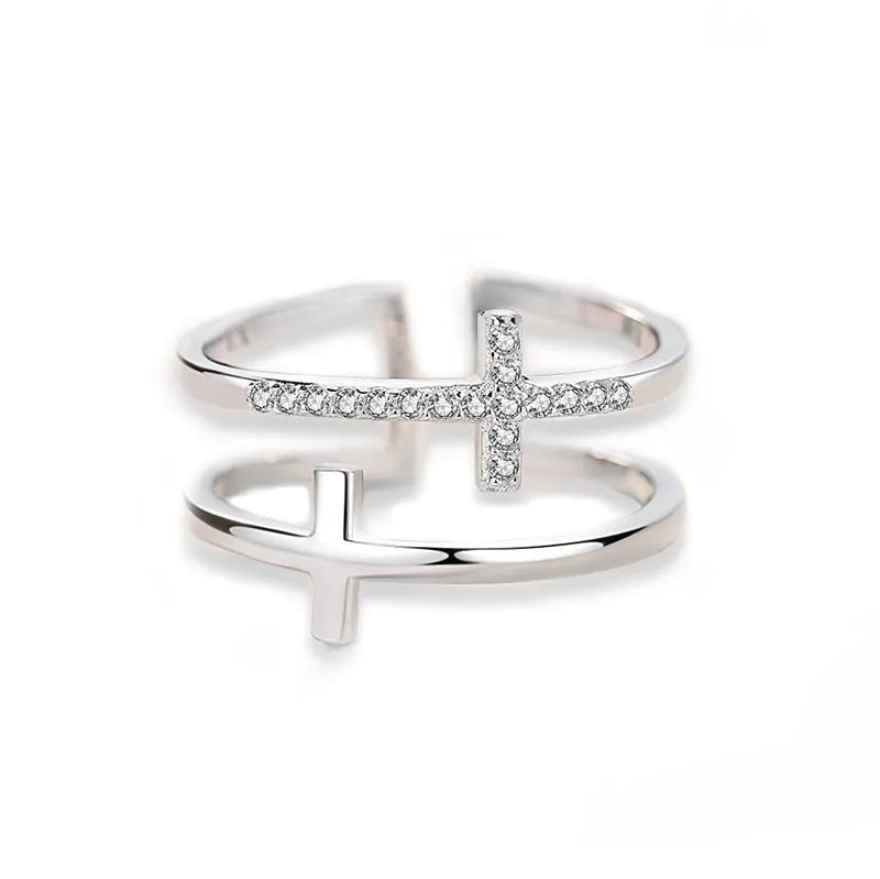Adjustable copper ring with double cross design, white gold electroplated finish, and zircon gemstones in sterling silver inlays