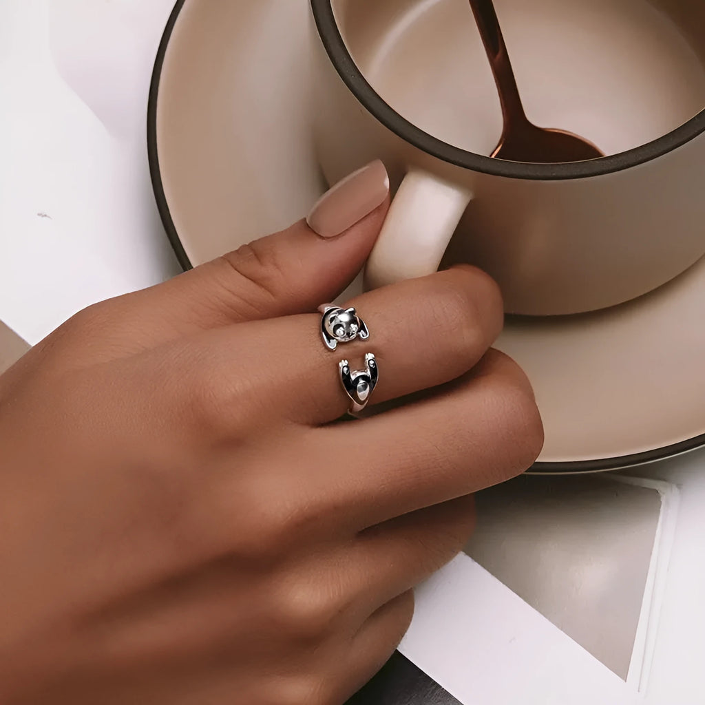 Adjustable sterling silver panda ring bracelet with white gold plating on a wrist.
