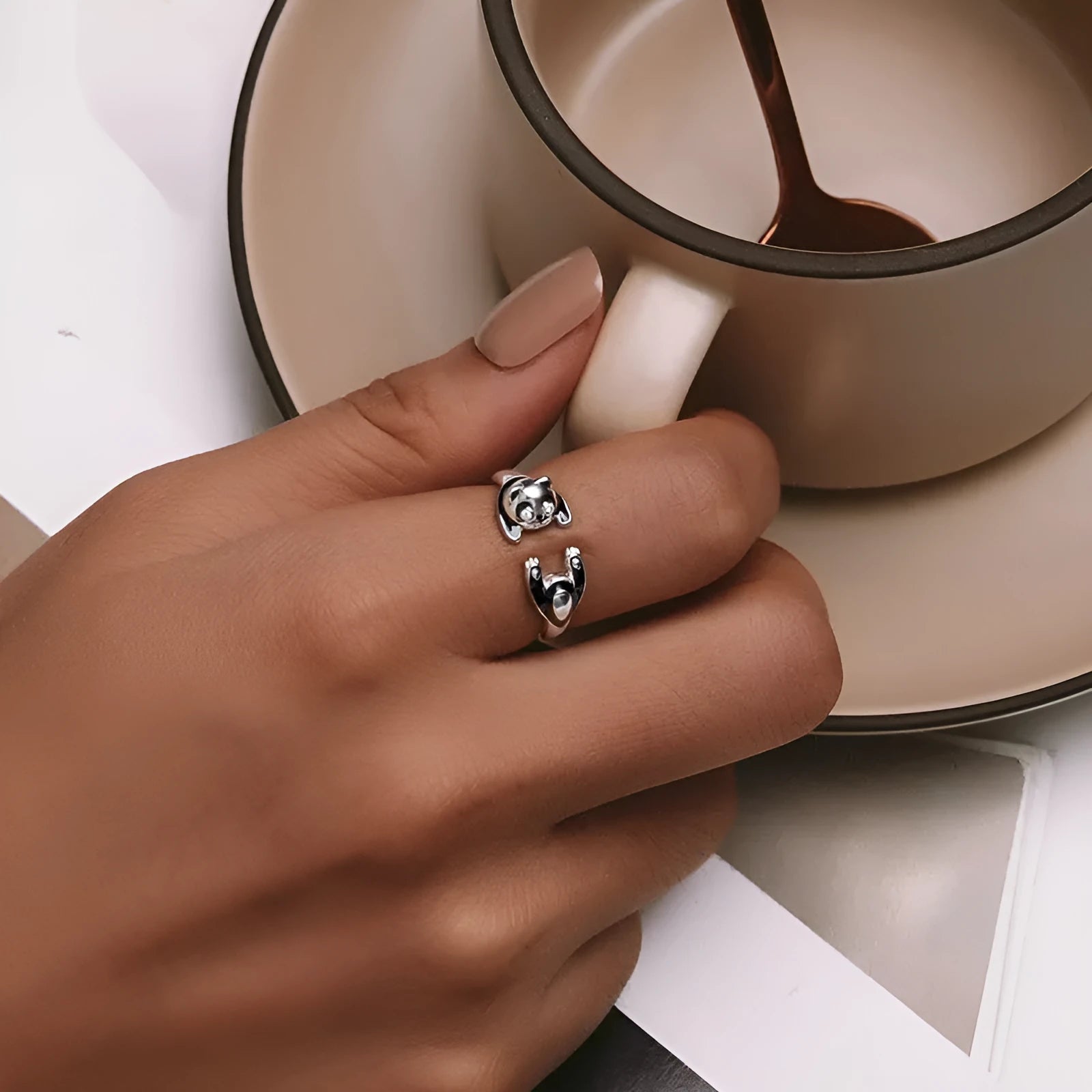 Adjustable sterling silver panda ring bracelet with white gold plating on a wrist.