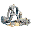 Blue floral dog collar with matching bow accessory on white background