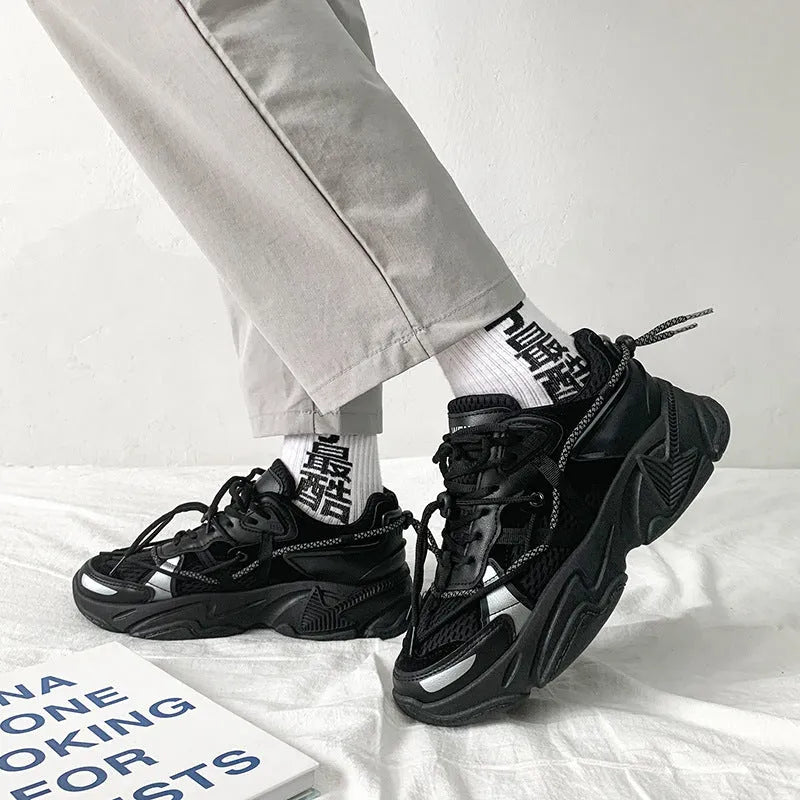 Men's white, black, and grey platform dad shoes with thick soles and lace-up front.