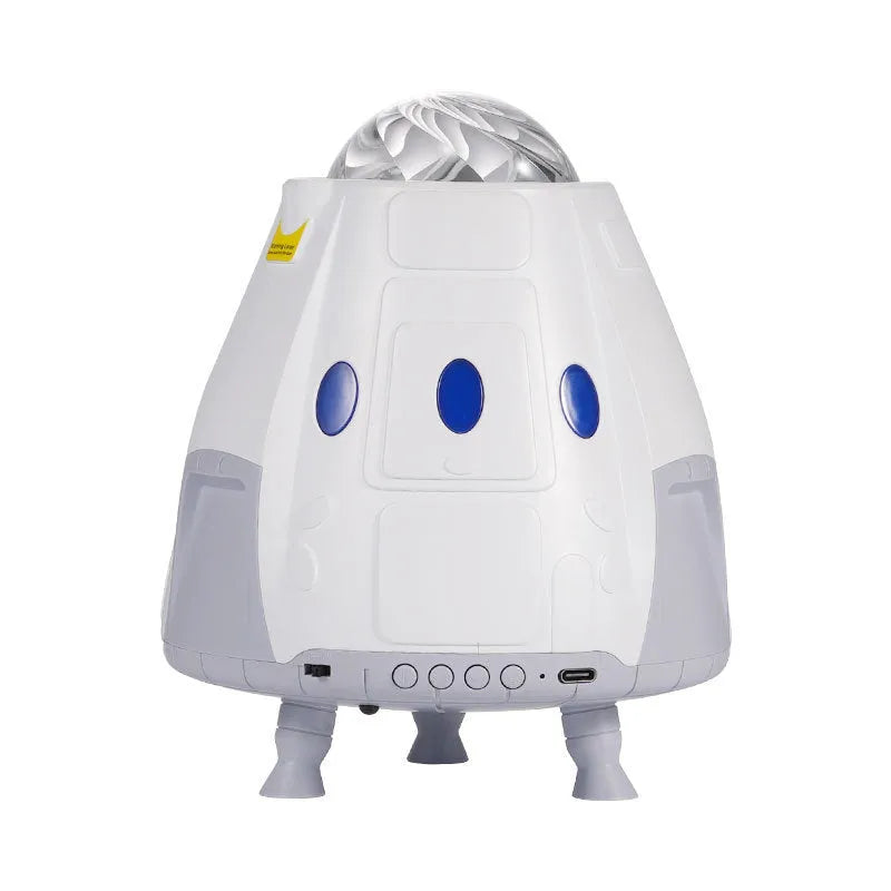 Creative USB space capsule starry atmosphere projection lamp in Space White with remote control on a bedside table