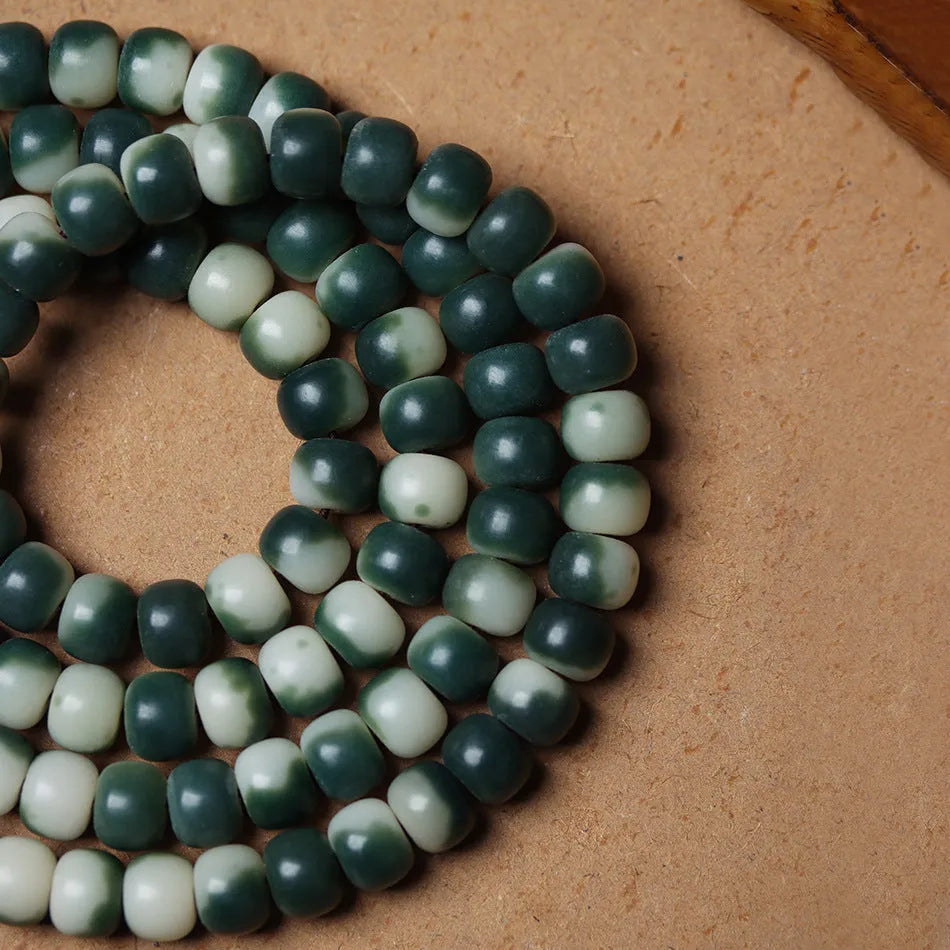 Lotus White Jade Bodhi Beads Bracelet with 8x10mm floating flowers beads on a neutral background