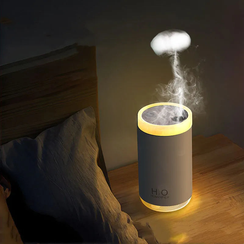 USB jellyfish humidifier creating smoke ring mist patterns with warm night light illumination