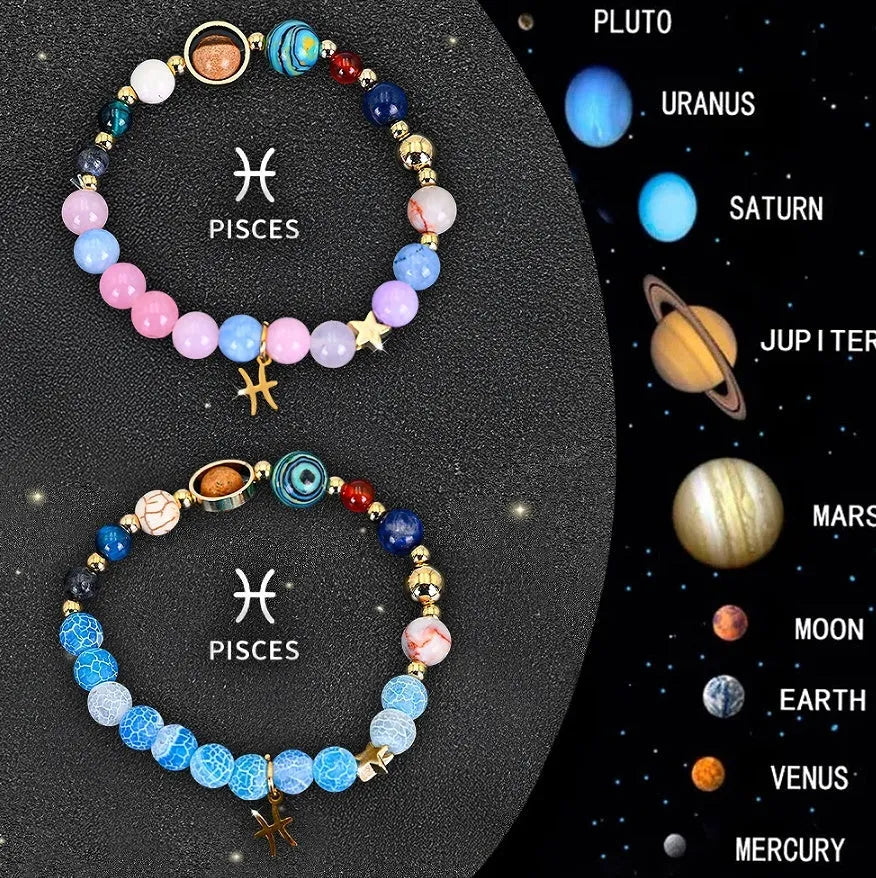 Set of two natural stone beaded bracelets with zodiac sign charms on a wrist.