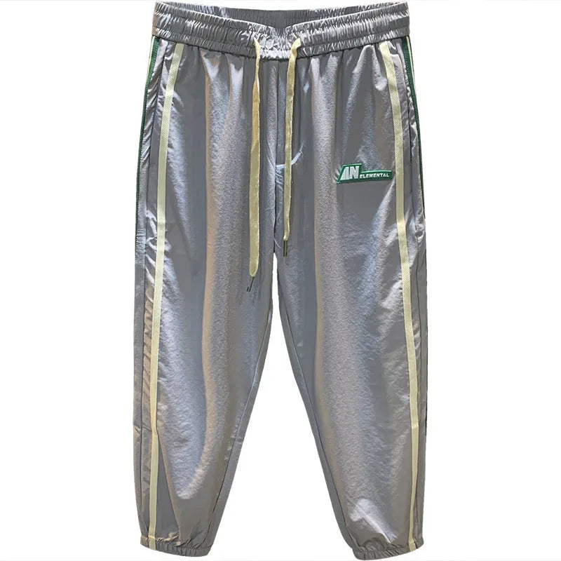 Men's solid black cotton harem pants laid flat, showing relaxed fit and mid waist design.