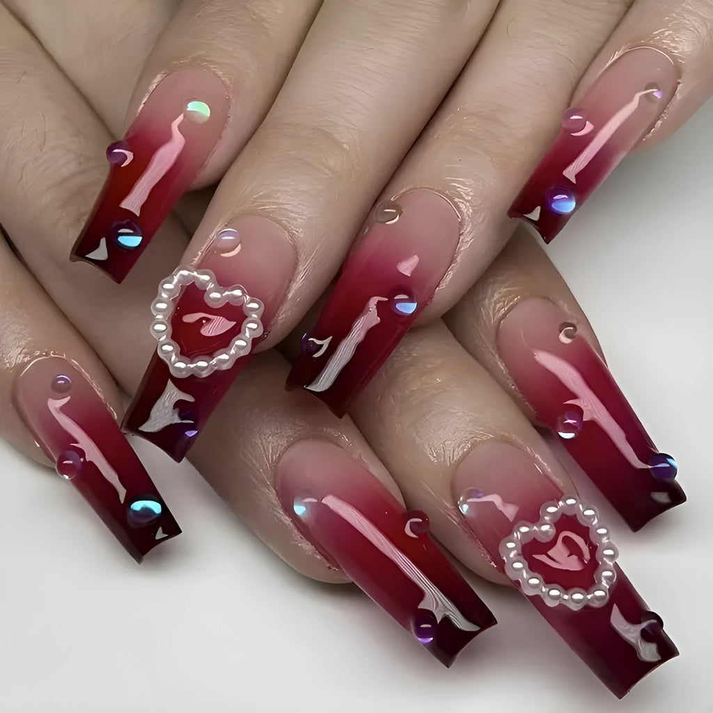 Wine red gradient fake nail tips with pearl heart decoration and plaid pattern in long ballet length style.